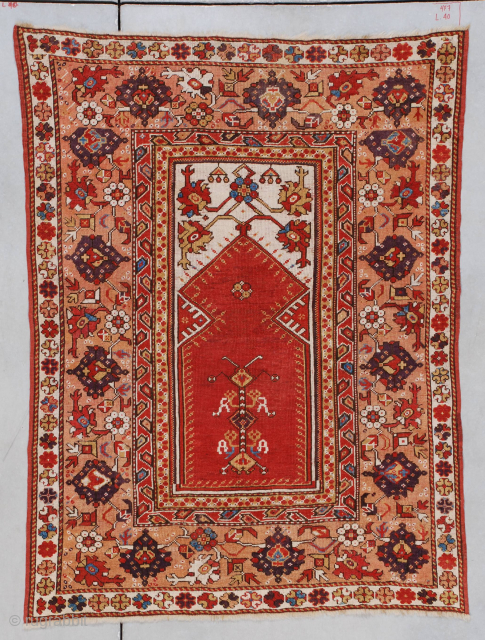 This circa 1825 Melas or Melez antique Oriental carpet #7177 measures 3’8” X 4’10”(115 x 152 cm). It has a tomato red prayer niche on an ivory ground with carnation motif in  ...
