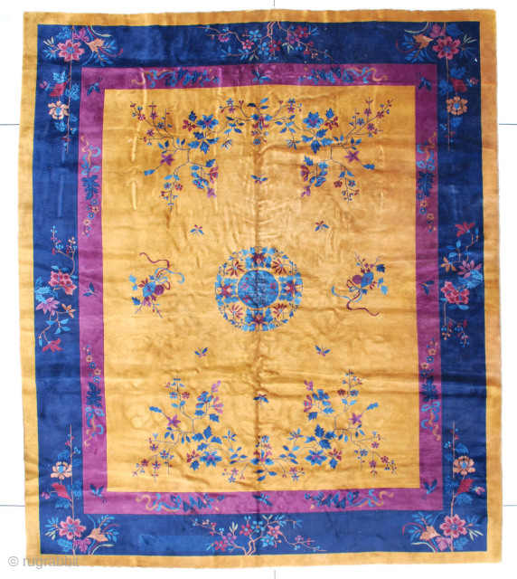 This circa 1920 Mandarin Chinese Antique Oriental rug measures 10’0” x 11’10” (304 x 362 cm). It has a dark gold field with a medium blue circle serving as a center medallion  ...