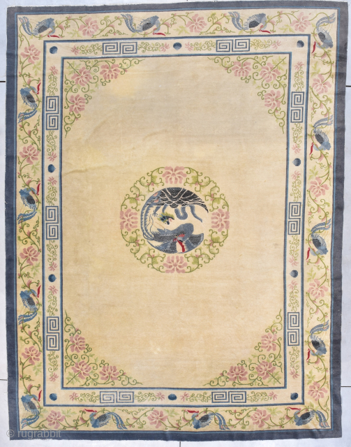 This third quarter 19th century Peking Chinese rug measures 9’1” X 11’’10” (277 x 363 cm). It has an old ivory colored field with a central medallion in the form of a  ...