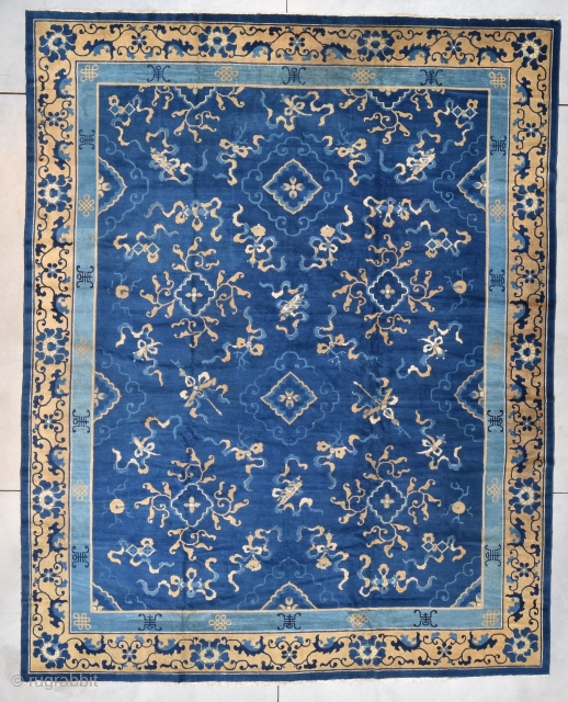 This circa 1890 antique Peking Chinese Oriental Rug measures 11’0 x 13’9” (335 x 424 cm). It has a medium blue field with an overall design that is slightly offset. The rug  ...