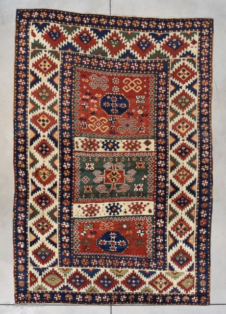 #7775 Antique Borchalou Kazak Caucasian Rug This third quarter 19th century Borchalou Kazak antique Oriental Caucasian carpet measures 5’2” x 7’5” (158 x 229 cm). The three panel field consists of two  ...