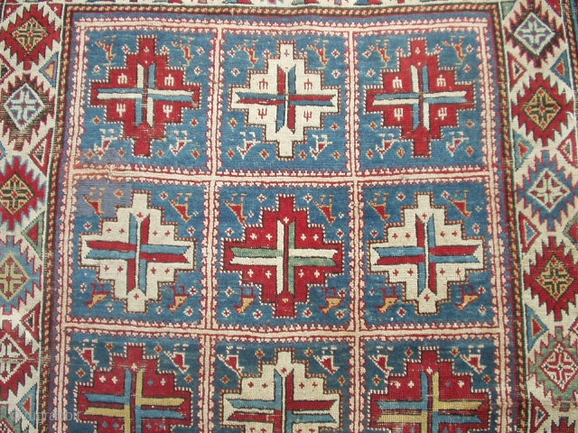 #6423 Shirvan Antique Caucasian Rug 
This circa 1870 Shirvan antique Oriental rug measures 4’0’ X 6’0’. It has fifteen panels with red and white medallions containing cross bars of ivory/blue , ivory/red  ...