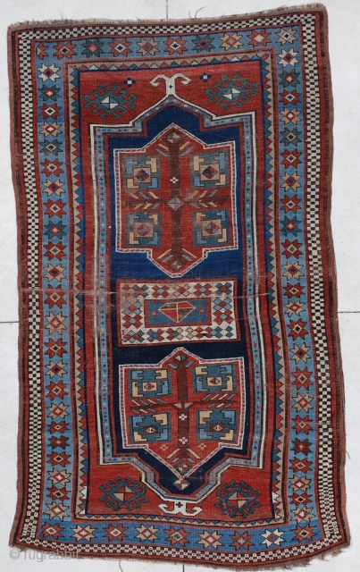 #6640 Kazak Antique Caucasian Rug This late 19th century Kazak antique Oriental Rug measures 4’1” x 6’10”. It has a double prayer motif in a Fachralo design. There are three medallions. Two  ...