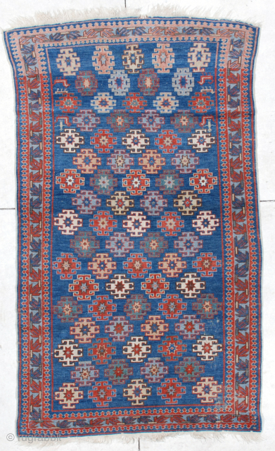 This 19th century antique Kuba #6471 measures 3’9” X 6’4”. It has latch hook medallions in red, ivory, yellow, green and pale blue on a medium blue ground with nice little groupings  ...