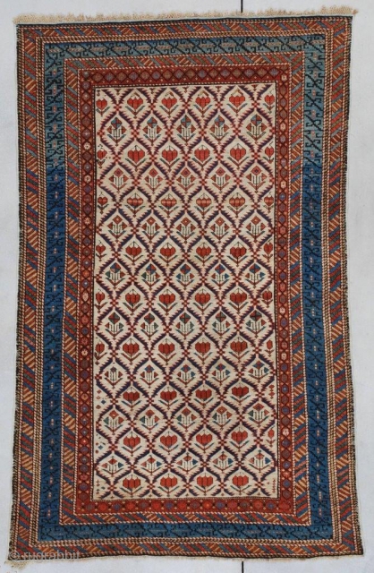 7347 Kuba/Shirvan This 19th-century Kuba/ Shirvan measures 4’0” x 6’4” (121 x 195 cm). ( has an ivory field divided into segmented diamonds set off by serrated blue edges each containing a  ...