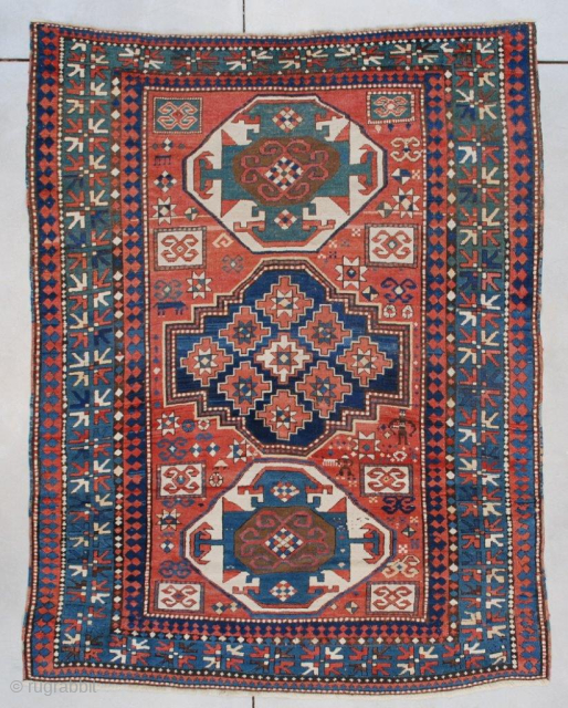 This circa 1880 Kazak antique rug measures 5’5” X 7’2” (167 x 219 cm). This is a very beautifully designed Kazak. It has two octagonal ivory medallions at either end of a  ...