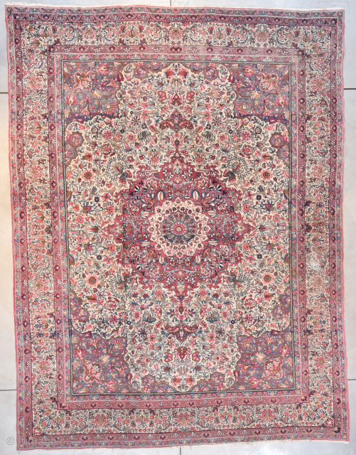 This circa 1920 Laver Kerman antique Persian rug measures 9’0” X 12’0” (274 x 372 cm). It has a large pulled medallion in pale red with an ivory center and a floral  ...