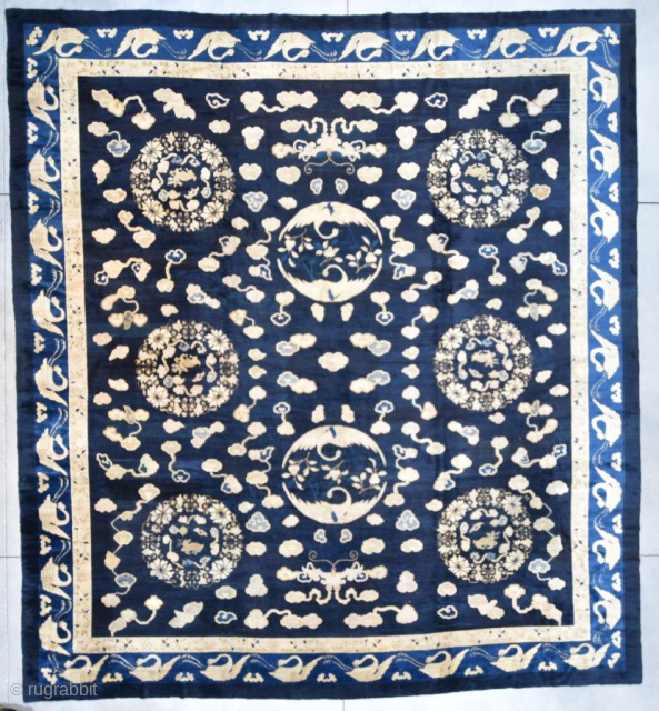 A FAVORITE! This circa 1860 antique Peking Chinese Oriental carpet rug #7080measures 14’0” x 15’5” (425 x 471 cm). It has a navy blue ground with six flower wreaths containing an antlered  ...