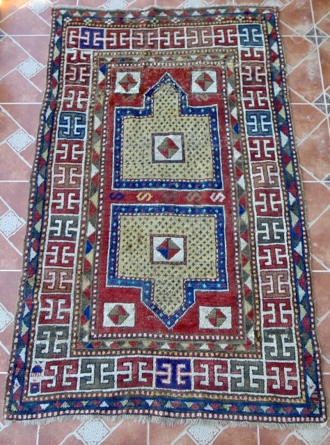 Antique double-niche Sewan Kazak with rare "split-shield" design, separated by a row of "S"- shaped motifs. The border design with bold, archaic "double T" shaped motifs. Size:  220 x 140 cm.  ...