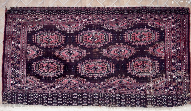 An antique part silk Saryk chuval, 165 x 89 cm. ( 5.4ft x 2.9ft) circa 1880. The dark purple-brown ground with Salor Guls. Each Gul inlaid with magenta silk and white cotton  ...