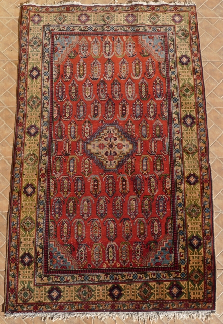 An antique  Chila Shirvan rug, Baku region, SE Caucasus. 6.7ft x 4 ft. Around 1900. The design with a small stepped ivory medallion, surrounded by boteh motifs on a red madder  ...