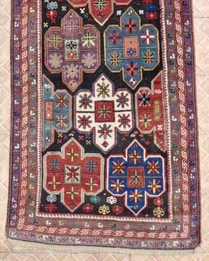 An Artsakh Karabagh long rug,( Nagorno Karabagh)  312 x  102 cm. Late 19th. century. 
 Dark chocolate brown ground with shield design with soft pastel tones: aquamarine, mauve, ocre, sea-green.  ...