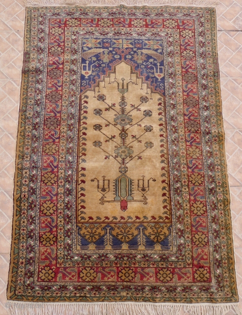 Ladik Prayer Rug, 180 x 120 cm. circa 1920/ 30. Classic tree of life design with oil jugs in a balance on an ivory ground.  In full-piled condition. Highly decorative as  ...