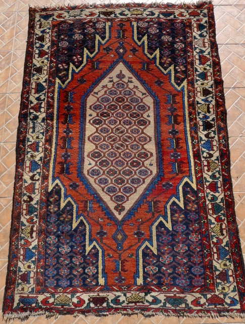 A Mazlaghan rug, cr. 1920, 6.5x4.2ft (198x129cm.)
 Very decorative piece with central honeycomb design and all the right colors incl. an abrashed madder-red field and soft yellow. Attractive white-ground tree border. In  ...