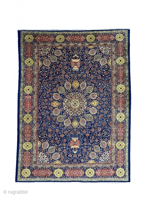 A Tabriz carpet with an 'Ardabil Carpet' medallion design, set against a blue foundation and complemented by red and yellow patterns on blue borders, often represents a beautiful and intricate piece of  ...