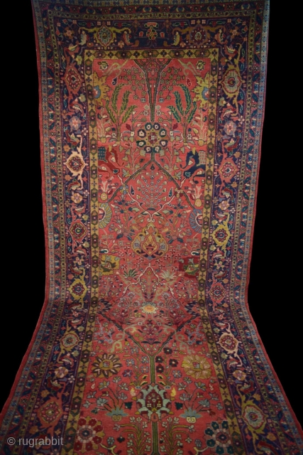 An Indian Vase design carpet with few old repairs measuring 670 x 152 cm.                   