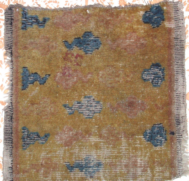 Inv. No. 5123  

17/18th c. Chinese rug fragment probably Gansu province.  Animal hair weft and wool warp.  Oxidized brown border.  Field design archaic clouds in ink (logwood?) and  ...