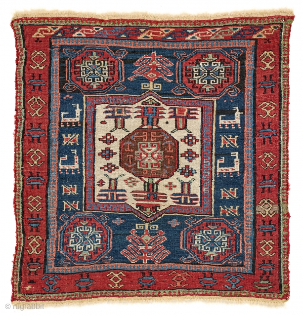 A very rare bag face finely woven in the sumakh technique, originally part of a khorjin. In the midnight blue field, a white cartouche is surrounded by four red octagons and two  ...