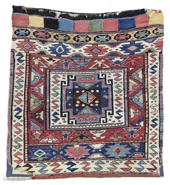 Half of a Khamseh Shahsavan double bag with a sumakh face and a kilim back. A white box enclosing a Memling gül surrounded by S-figures lies at the centre of the red  ...