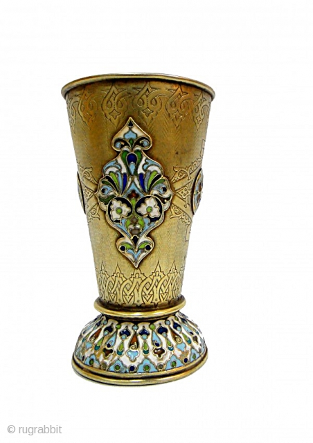 A RUSSIAN ENAMLE SILVER BEAKER GOLD PLATED

A RUSSIAN SILVER-GILT AND CHAMPLEVÉ ENAMEL BEAKER The conical silver gilt goblet on spreading foot, blue cloisonné enamel strap work enclosing multi color foliate and dot  ...