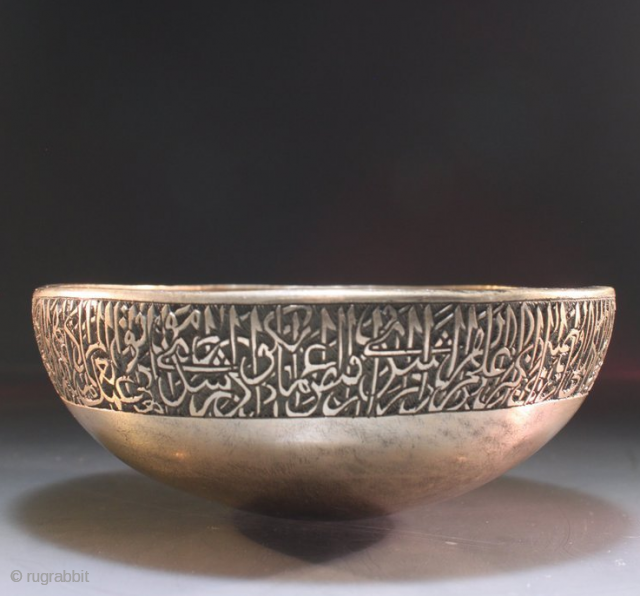 A Mughal Deccan bronze calligraphic bowl, India, Golconda or Bidar, 16th century of squat round bowl form, an engraved Arabic calligraphic around the bowl, the spherical base encircled by a splayed ridge,  ...