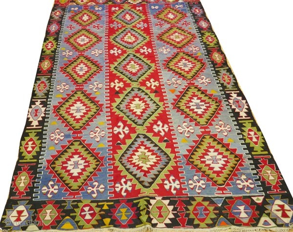 Large Turkish Kilim rug c. 1900. Vibrant colors, some small repairs as pictured in 4th photo. Braided fringe. Clean and odor-free, includes tags from professional cleaner and art gallery where purchased. 

5'9"  ...