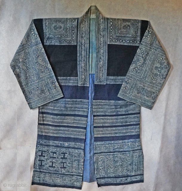 Vintage Chinese Miao Ethnic Minority long jacket...  
intricate batik using indigo dye...all hand sewn...
hand woven ribbon strips decorate the lower back... 
easy to wear, field tested by me...
looks great hanging on  ...