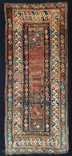 Caucasian runner, possibly a Gendje?, 19th.c. Much worn in the field and corroded brown but nicely composed with great abrashed colors on the outer "snake" border.
270 x 115 cm    