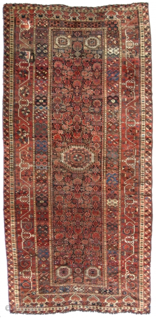 Beshir Ersari Main Carpet, 6'7 x 13'10. Circa 1875. Nearly complete, and scarce so, with Herati and Khotan main borders and the five-medallion Herati field pattern. Very restorable, with the usual scattered  ...