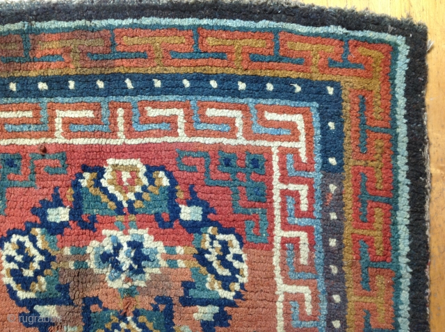 Sitting Carpet.
Archaic composition with bold border structure.
Goat hair foundation. Vegetal dyed wool pile.
32 x 32 inches
Village weaving
19th century
TIbet

* conditions: some minor discoloration. Requires minor restoration....Broken selvedge (visible on lower left side).two broken  ...