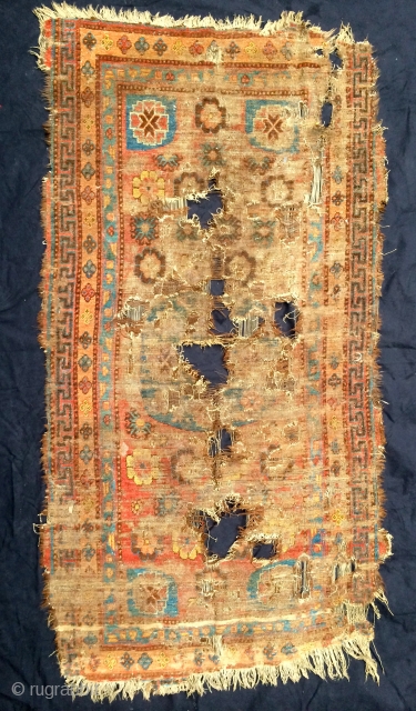 pretty much fragmented rug from the khotan oasis, early 19th century, 193 x 99cm, 6'4" x 3'3", came out of tibet, as found condition and in need of water    