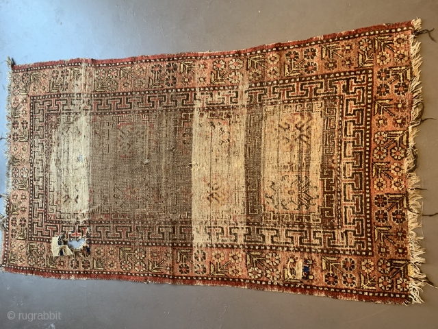 Pretty battered Khotan rug. First half 19th century, 220 x 112 cm                     