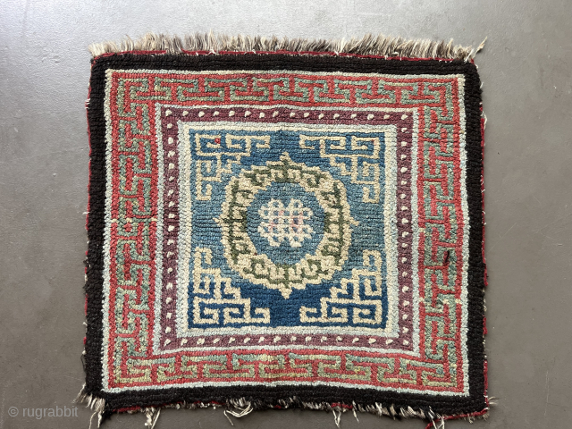 
A central Tibetan Khamdrum-style seating rug 66 x 71 cm. The partially visible border of red fabric is evidence of its use as a seating rug. There is a colour that could  ...