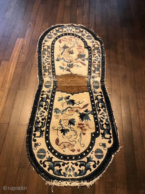 lovely white ground ningxia saddle rug, west china, 19th century, 130 x 58 cm, 4'3" x 1'11", upper ends open, one half partly worn, no restoration       