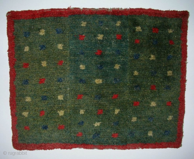 MAT, Tibet, early 20th century, cm 76x62.
Tibetan rugs in so-called ‘tsuk-truk’ technique (woven in narrow stripes - then joined - on small back strap looms) are probably the survivors of a nearly  ...