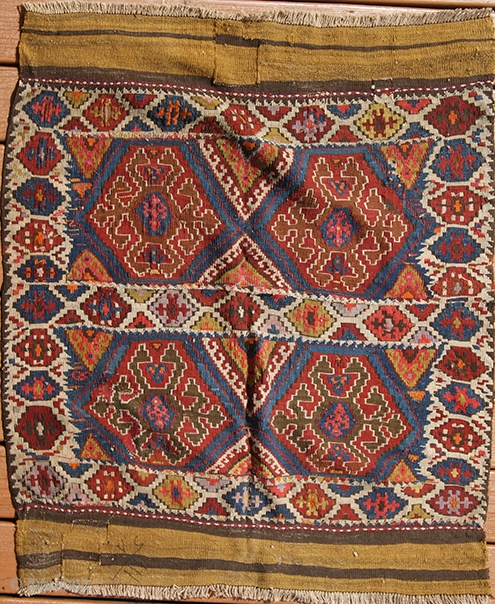 Kilim panel (Mafrash) #3254
Origin: Iran. Shahsavan, Khamseh area. 
Size: 42" X 44" 
Age: 2nd quarter 20th c. 
Wool. 
Extra weft wrapping. Ends are banded plain weave. 

An eye dazzling effect is achieved  ...