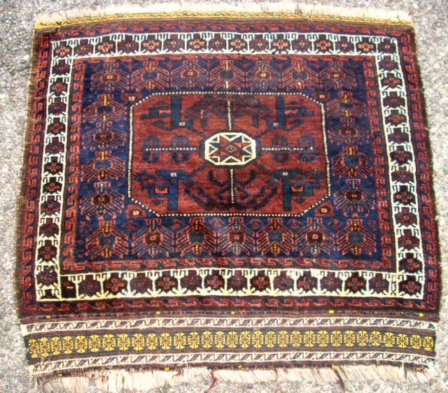 antique Baluch bagface. Size: 82 x 73 cm. Excellent wool. Fine knotting. Used. Some small repairs.                 