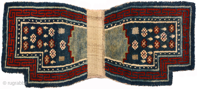 Striking Tibetan ‘wasp-waisted’ under saddle carpet (makden) from the 1800’s / 19th century. The colours are from all natural dyes (with the rich red and dark blue super saturated) and undyed white  ...