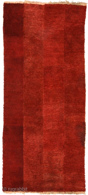 Lustrous burgundy coloured beautifully abrashed four-panel Tibetan tsuktruk with soft deep pile. Woven circa 1900 with hand-spun wool warp and weft and pile which has been coloured using natural organic dye (with  ...