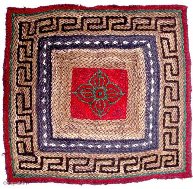 Tibet. Unique pile-less seating square woven in a very interesting and unusual knotting style, being either rural or nomadic work with primarily natural dyes, and un-dyed lustrous wool. The center square features  ...