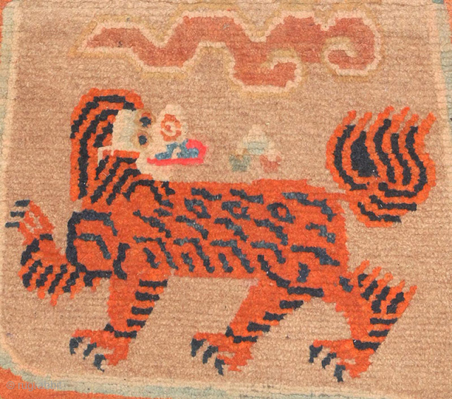 The portrayal of a tiger was a powerful symbol of high rank in Tibet with both the secular upper class and the religious class using weaving's depicting them. This Tibetan 'butterfly' shaped  ...