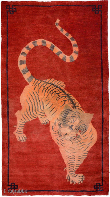 Impressive tiger carpet from the Inner Mongolian region of China. The tiger is very well rendered against a red background and is shown in the classic ‘paw on paw’ stance and a  ...