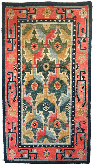 Striking Tibetan khaden with a lovely abrashed strawberry-red border and two shades of saturated abrashed green in the center field. A rare design ‘twist’ is the asymmetric nature of the design in  ...