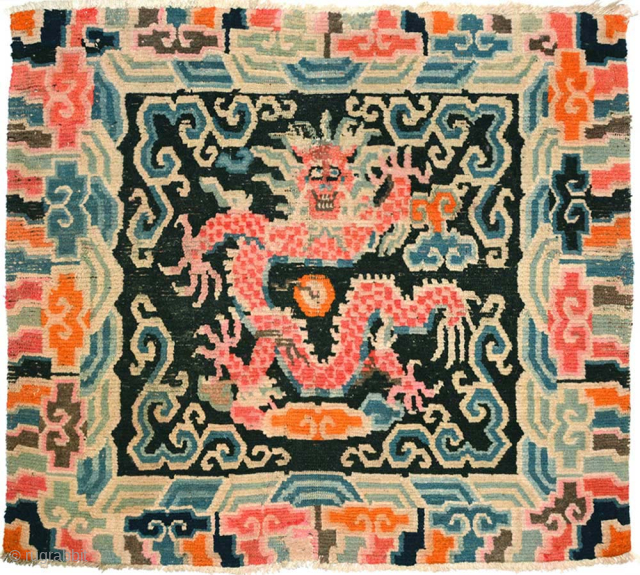 Tibetan seating carpet depicting a single front-facing five clawed dragon, being unusual in that it shows the dragon in profile, as opposed to 'side-on' as is more often the case. The size  ...