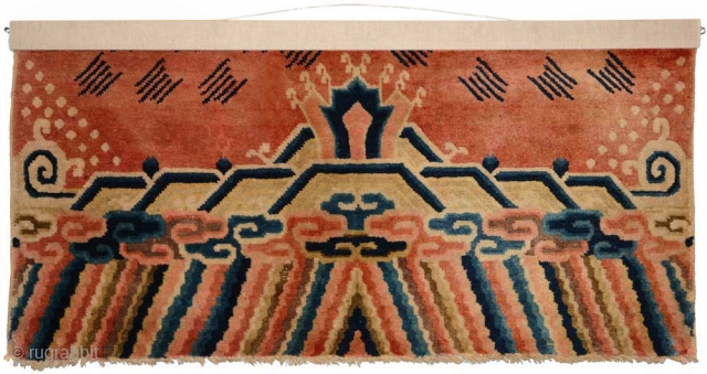 The end fragment of a longer carpet, most likely made in the Baotou-Suiyuan region of China circa the early 1900’s, and which has (much more recently) been professionally mounted so as to  ...