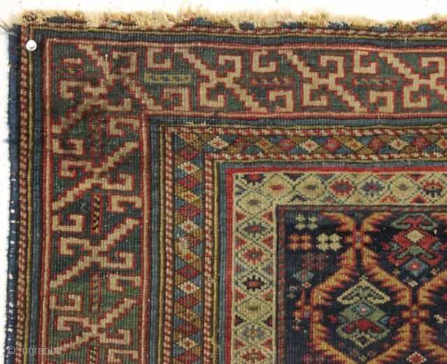 Early east caucasian rug in distressed condition. Lovely green border and a nicely drawn colorful lattice with a large variety of delicate inset elements. Rug is cut and crudely resewn lenghtwise. A  ...