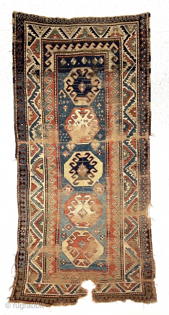 Early Kazak rug. Classic design elements. All natural colors. Charming border drawing. Obviously not for the condition collector. Rips, tears, holes, creases and more. Structurally ok. Red abrashed to light yellow at  ...