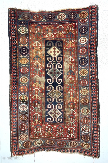 Antique Caucasian Kazak or karrabagh rug with an interesting and archaic design. Pretty light blue border. Some decent pile but essentially ravaged by wolves condition. Wear, tears, stains, black oxidation, edge gouges  ...