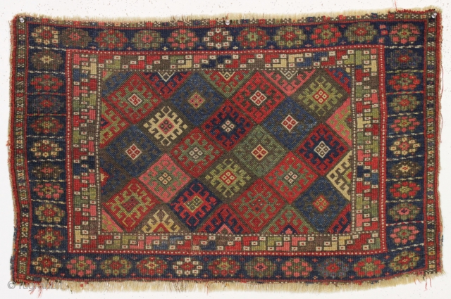 antique large jaf kurd bagface. Classic diamond design field with one of the more interesting minor borders. At least 9 all natural colors. "as found", very dirty with remnant selvages and unraveling  ...