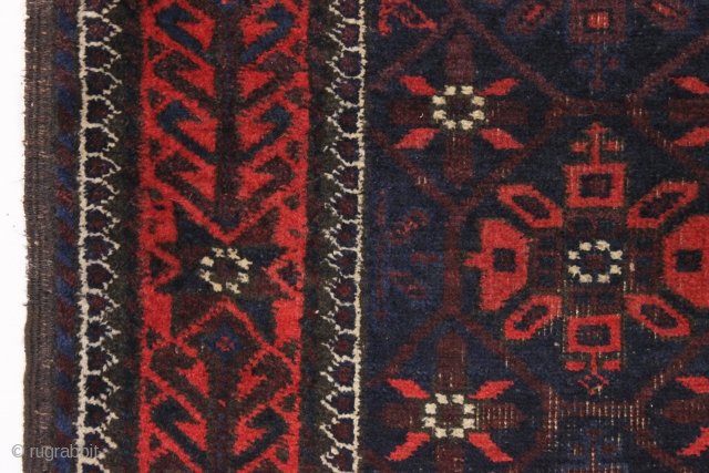 Old baluch rug with mina khani design field and an interesting border. Unusually small size for the type. All good colors featuring a strong ember red. Overall fair condition with mostly good  ...